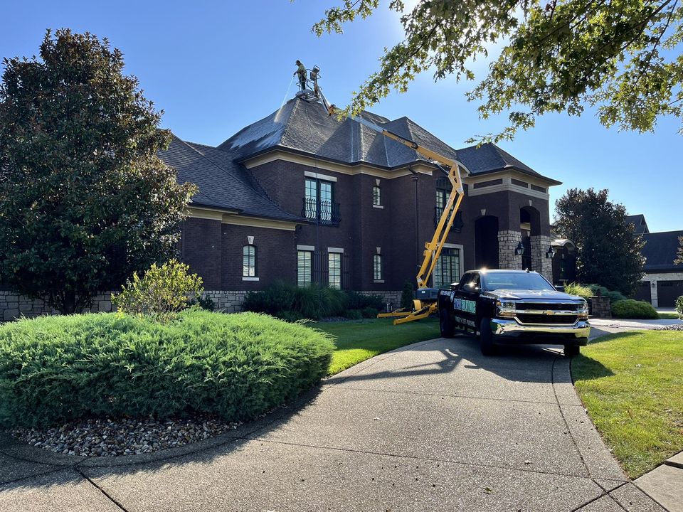 Cleaning roof with soft washing technique on a residential property
