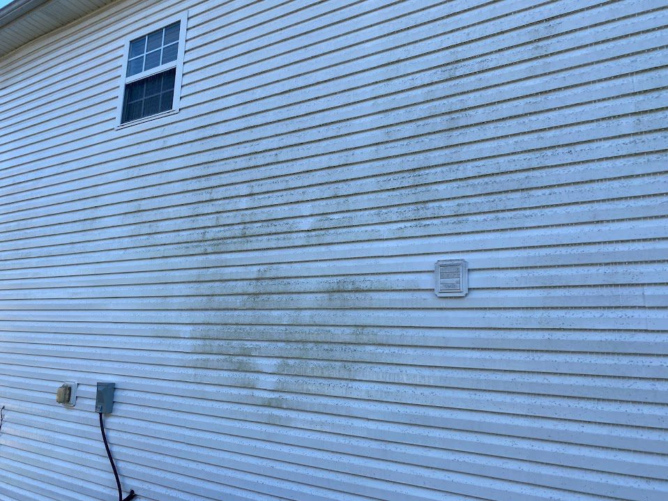 Pressure washing home exterior in Simpsonville, KY for curb appeal