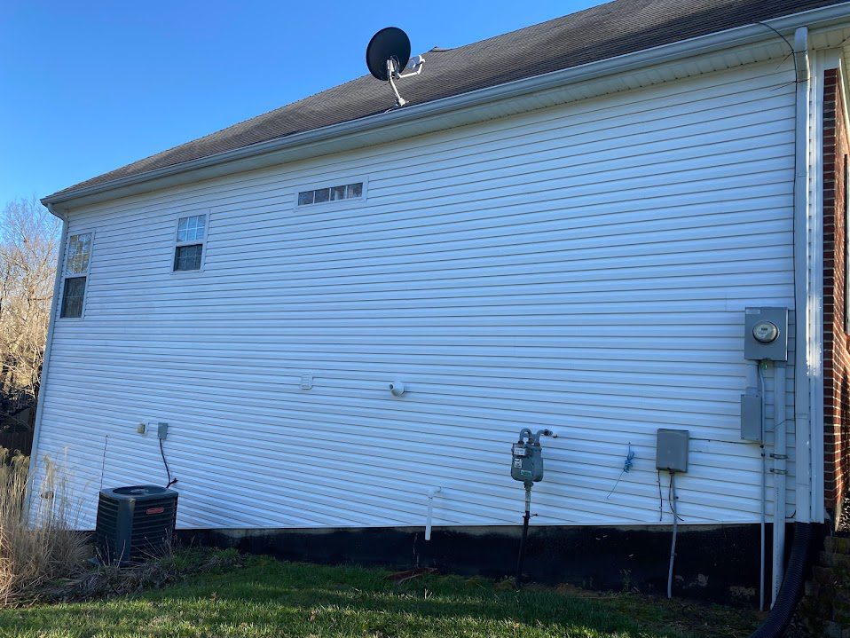 Pressure washing home exterior in Simpsonville, KY for curb appeal